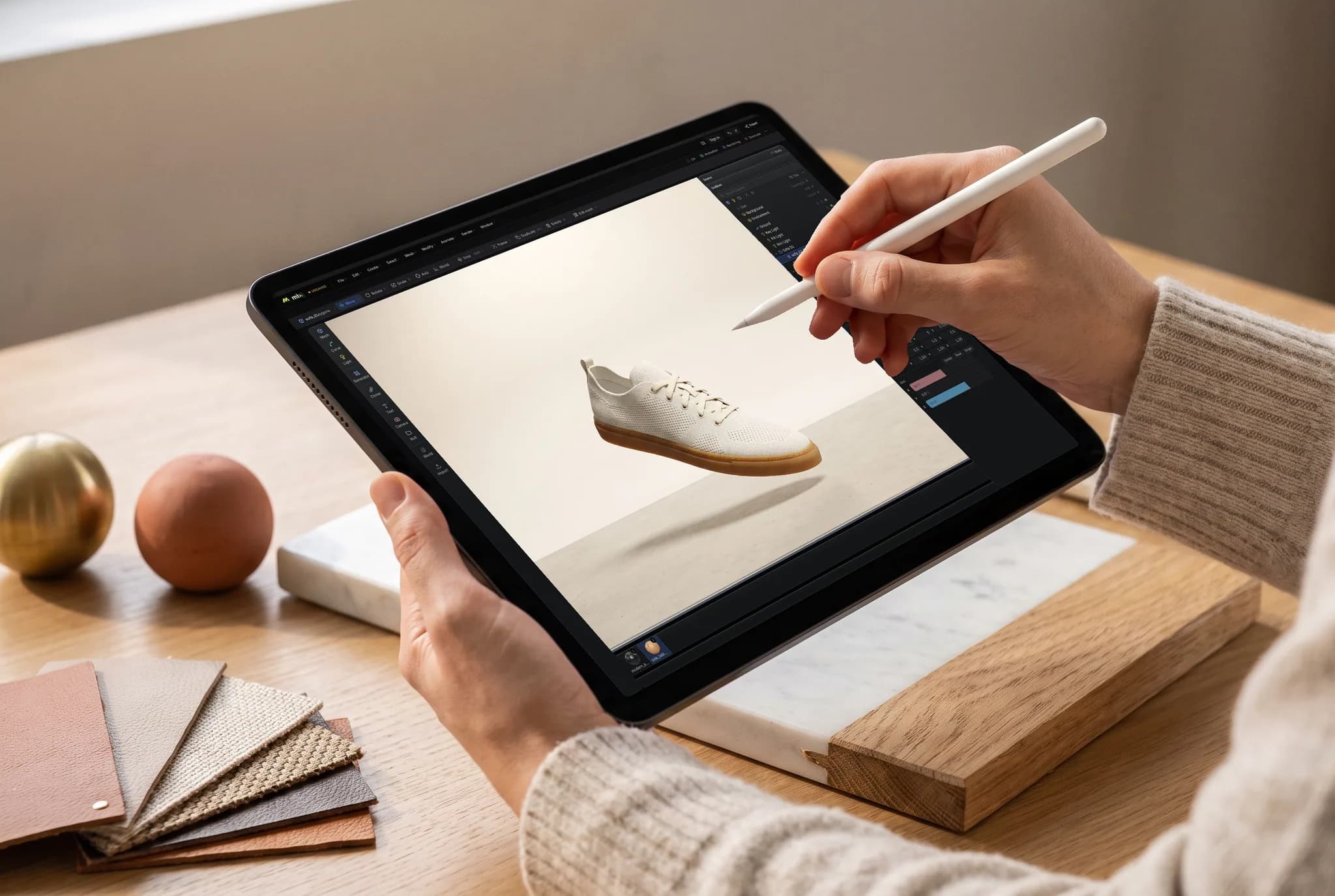 mixos Studio open on an iPad showing a single off-white knit sneaker floating above its shadow, held in both hands, an Apple Pencil touching the screen.