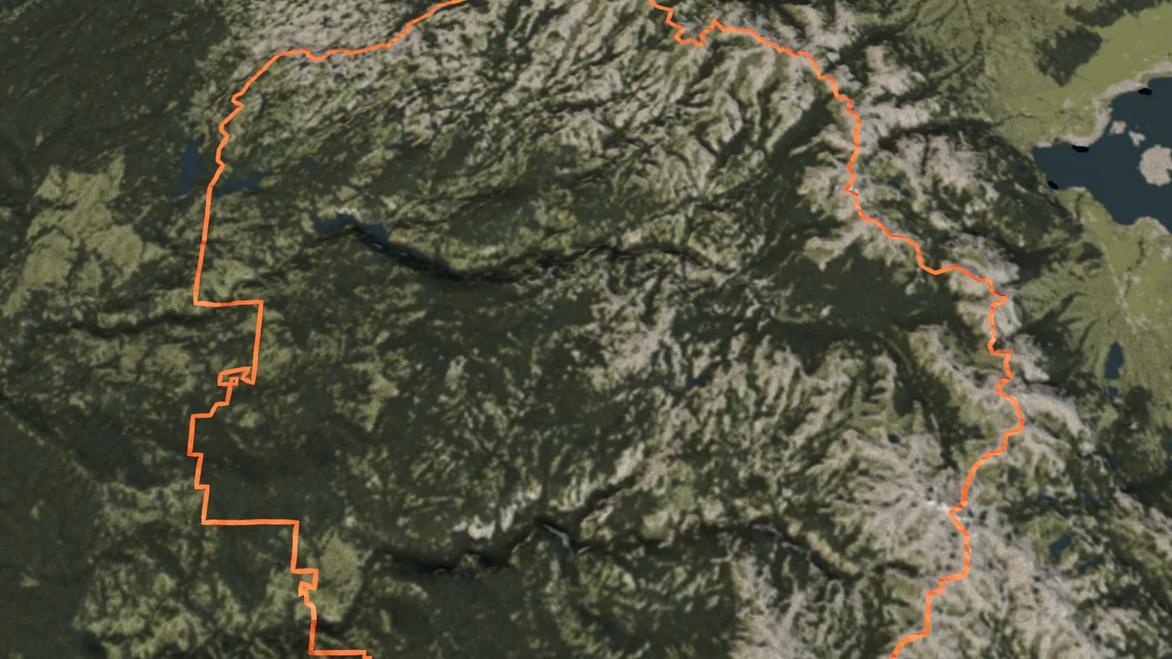 The boundary of Yosemite National Park drawn in orange across a large real landscape