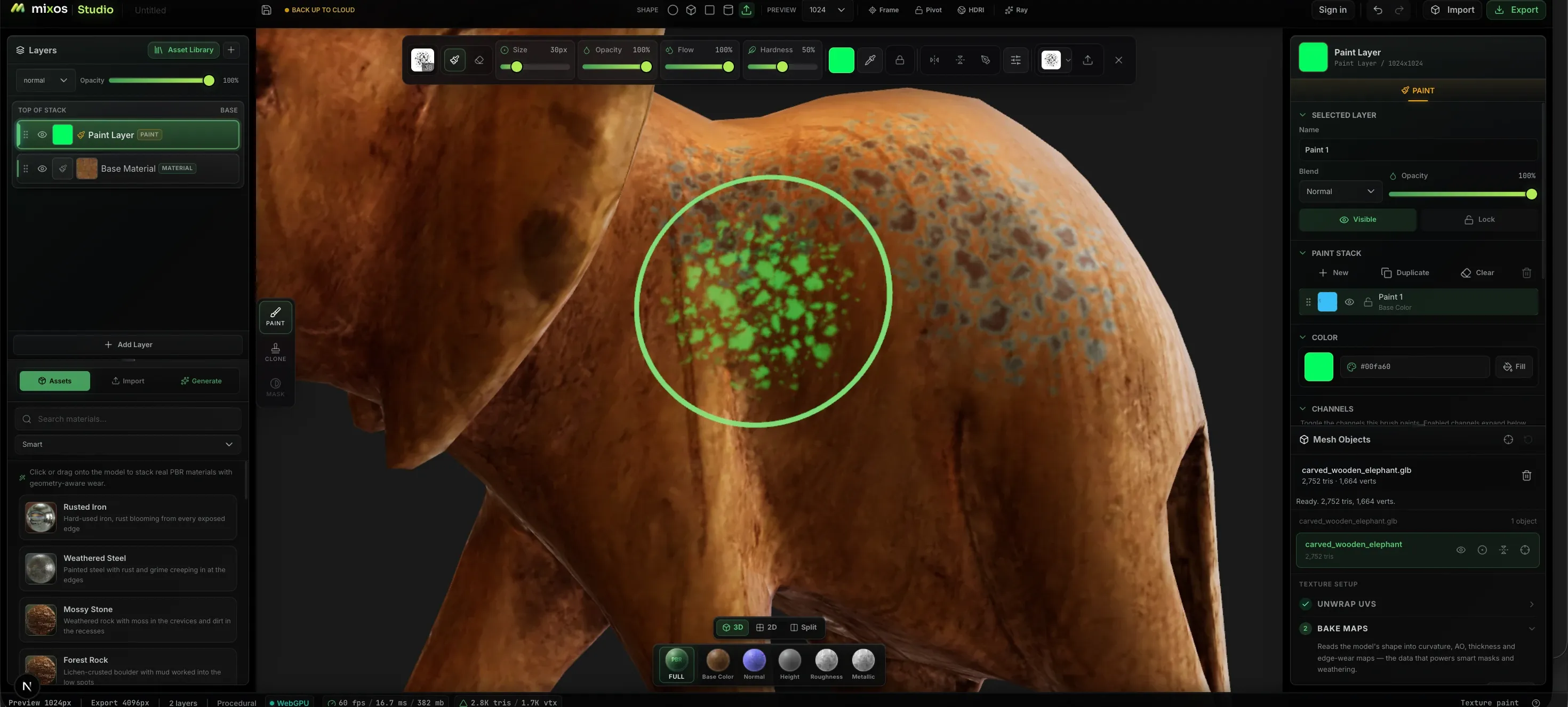 A carved wooden elephant being hand-painted in Mixos: a soft brush lays a green stroke across its flank, with the paint layer sitting above the base material in the stack and a panel exposing the brush's color, opacity, flow and per-channel paint settings.